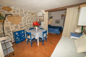 a living room with a table and chairs and a bedroom at Condominio Dunelba in Marina di Campo