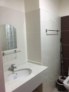 a white bathroom with a sink and a mirror at Fully Furnished Studio Unit in Mandaue City, Cebu with Fast WiFi and Cable TV in Cebu City