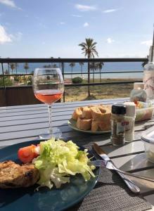 a table with a plate of food and a glass of wine at Sierra Y Mar in Mazarrón