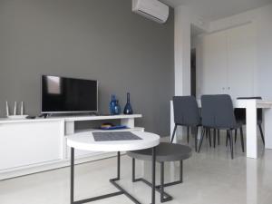 a living room with a table with a tv and chairs at Sierra Y Mar in Mazarrón