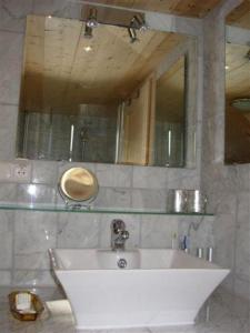 a bathroom with a white sink and a mirror at Talblickhof in Sankt Georgen im Schwarzwald