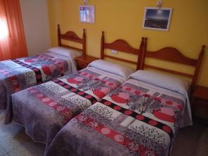 Postel nebo postele na pokoji v ubytování Hostal Avenida