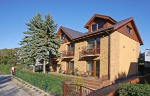 a large brick house with balconies and a tree at Vila Medus in Palanga