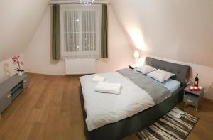 a bedroom with a large bed and a window at Apartamenty Elbląg in Elblag