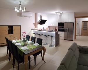 a kitchen and dining room with a table and chairs at Apartamenty Elbląg in Elblag