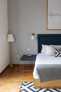 Un dormitorio con una cama azul y una mesa azul en Markee Hotel Boutique, en Querétaro