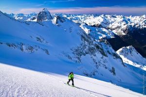 a person is skiing down a snow covered mountain at St JORDI CONF in Pas de la Casa