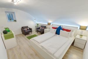 a living room with a large white couch with pillows at Lovely Apartment at Basilica in Budapest