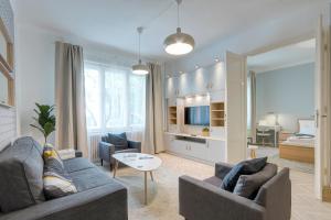 a living room with two couches and a bedroom at Gálya Apartment in Budapest
