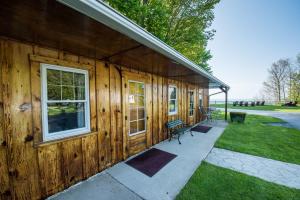 a wooden building with a porch and a bench at Lakeview on the Lake in North East