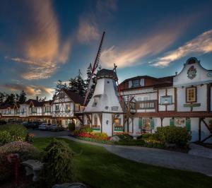 a building with a windmill on the side of it at Auld Holland Inn in Oak Harbor