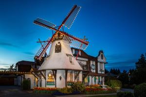 a house with a windmill in front of it at Auld Holland Inn in Oak Harbor