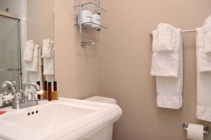 a bathroom with a sink and a toilet and towels at Furnished Studio in the South End #4 in Boston +5 photos