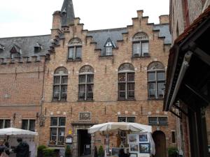 a large building with a clock on the front of it at Hotel Duc De Bourgogne in Bruges