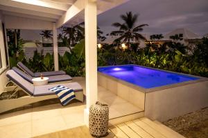 a swimming pool on a patio at night at Tamanu on the Beach in Port Vila