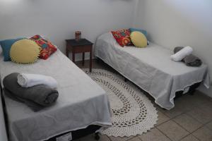 two beds with pillows on them in a room at Edifício José Augusto in Betim