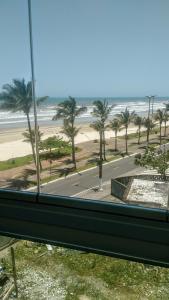 a view from a window of a beach with palm trees at Residencial Bela Vista in Solemar