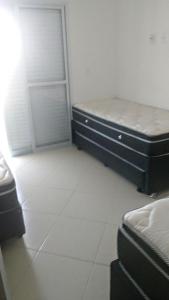 a bedroom with a bed and a closet and a door at Residencial Bela Vista in Solemar