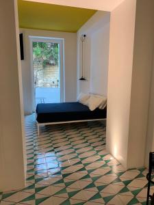 a bedroom with a bed in a room with a window at PrimoPianoPosillipo in Naples