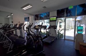 a gym with treadmills and ellipticals in a room at Park Royal Beach Mazatlán in Mazatlán