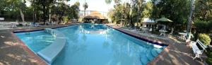 a large blue swimming pool with a slide at Hotel Valles in Ciudad Valles