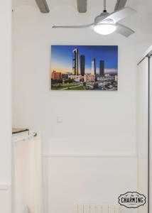 a city skyline photographic print on a wall in a bathroom at Charming Puerta de Toledo II in Madrid