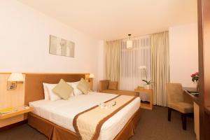 Ένα ή περισσότερα κρεβάτια σε δωμάτιο στο Liberty Hotel Saigon Parkview