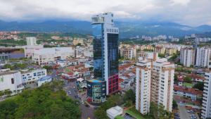 an aerial view of a city with a tall building at Hotel Roseliere Bucaramanga in Bucaramanga