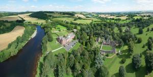 an aerial view of a castle and a river at Dryburgh Abbey Hotel in Melrose