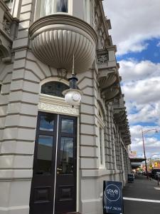 a building with a revolving door on a street at Bull and Mouth Hotel in Maryborough