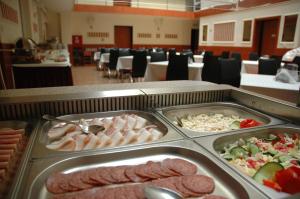 a buffet with different types of food in a cafeteria at Atlantic Hotel in Budapest