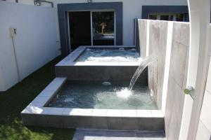 a plunge pool with a fountain in a yard at Mas de l Aire in Corneilla-del-Vercol