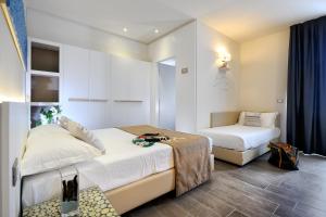 a hotel room with two beds and a mirror at Hotel Life in Rimini