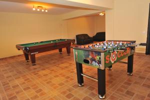 two snooker tables in a room with at Pensiunea Ursul Carcotas in Fundata