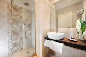a bathroom with a sink and a shower at Hotel Life in Rimini
