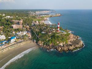 an aerial view of a lighthouse on a island in the ocean at The Ayur Villa in Kovalam