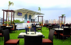 a restaurant with tables and chairs on a roof at Gokulam Park Sabari-Siruseri SIPCOT in Chennai