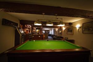 a pub with a pool table in a room at The Angel Hotel in Helston