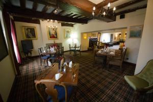 a restaurant with tables and chairs in a room at The Angel Hotel in Helston