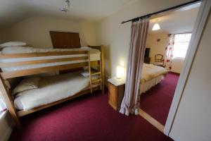 a bedroom with two bunk beds and a window at The Angel Hotel in Helston +53 photos