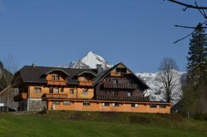 a large wooden house on top of a hill at Gasthof Tetter in Schladming