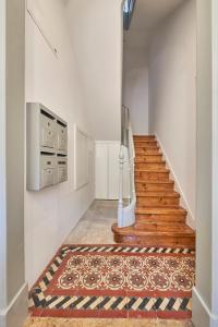 a hallway with a staircase with a rug at Casa Eclea Lisbon Belem Design Apartment in Lisbon