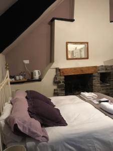 a bedroom with a bed with a stone fireplace at The Tanners Arms in Devynock