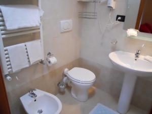 a small bathroom with a toilet and a sink at Locanda Villa Moderna in Genoa