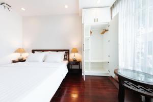 a bedroom with a bed and a glass table at VietHome-Doorstep to Hoan Kiem Lake in Hanoi