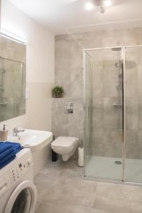 a bathroom with a shower and a toilet and a sink at Apartament 22 in Sopot