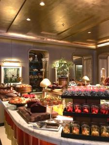a counter with a variety of pastries on it at Hotel de Crillon in Paris