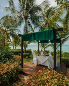 a table set up for a picnic at the beach at Bo Phut Resort and Spa - SHA Plus in Bophut