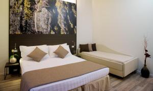 a bedroom with a bed and a couch at Hotel Life in Rimini