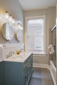 a bathroom with a sink and a mirror and a window at 414B Waldburg st · 2 Bedroom Oasis near Forsyth Park in Savannah